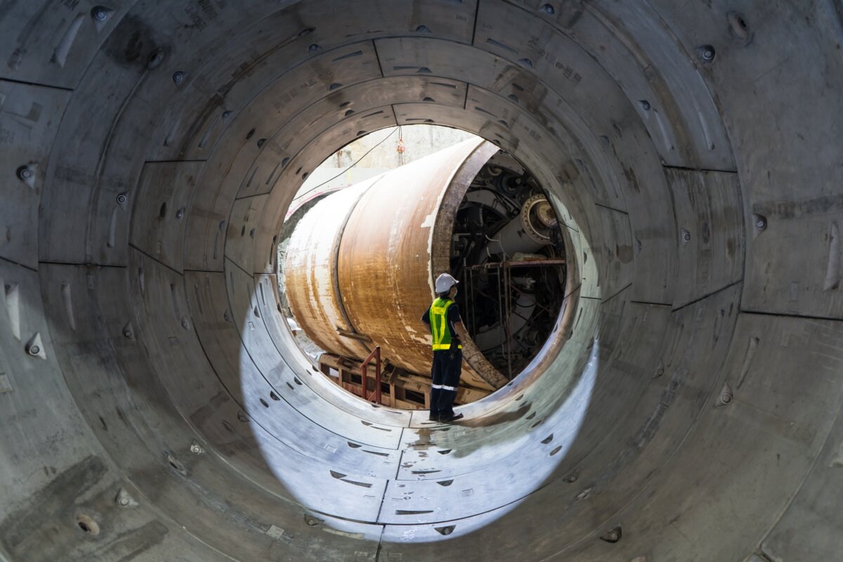 An engineer inspecting a large tunnel